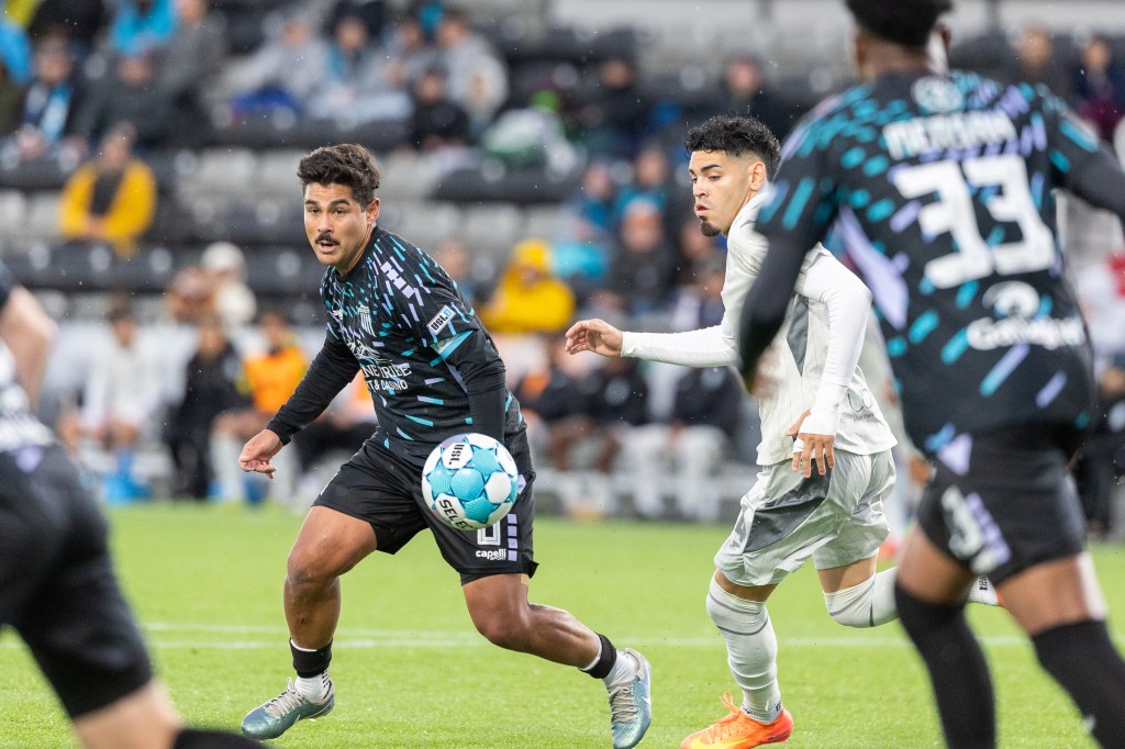 A soccer ball floats in front of Collin Fernandez in game action vs a Las Vegas Lights defender