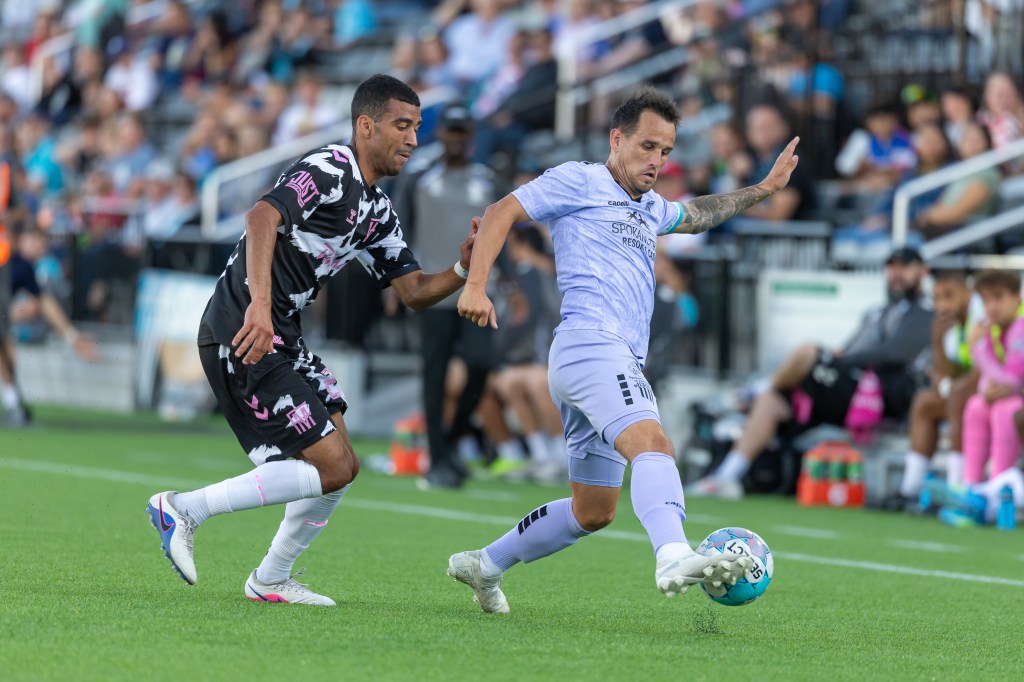 Luis Gil dribbles the ball past a Forward Madison defender