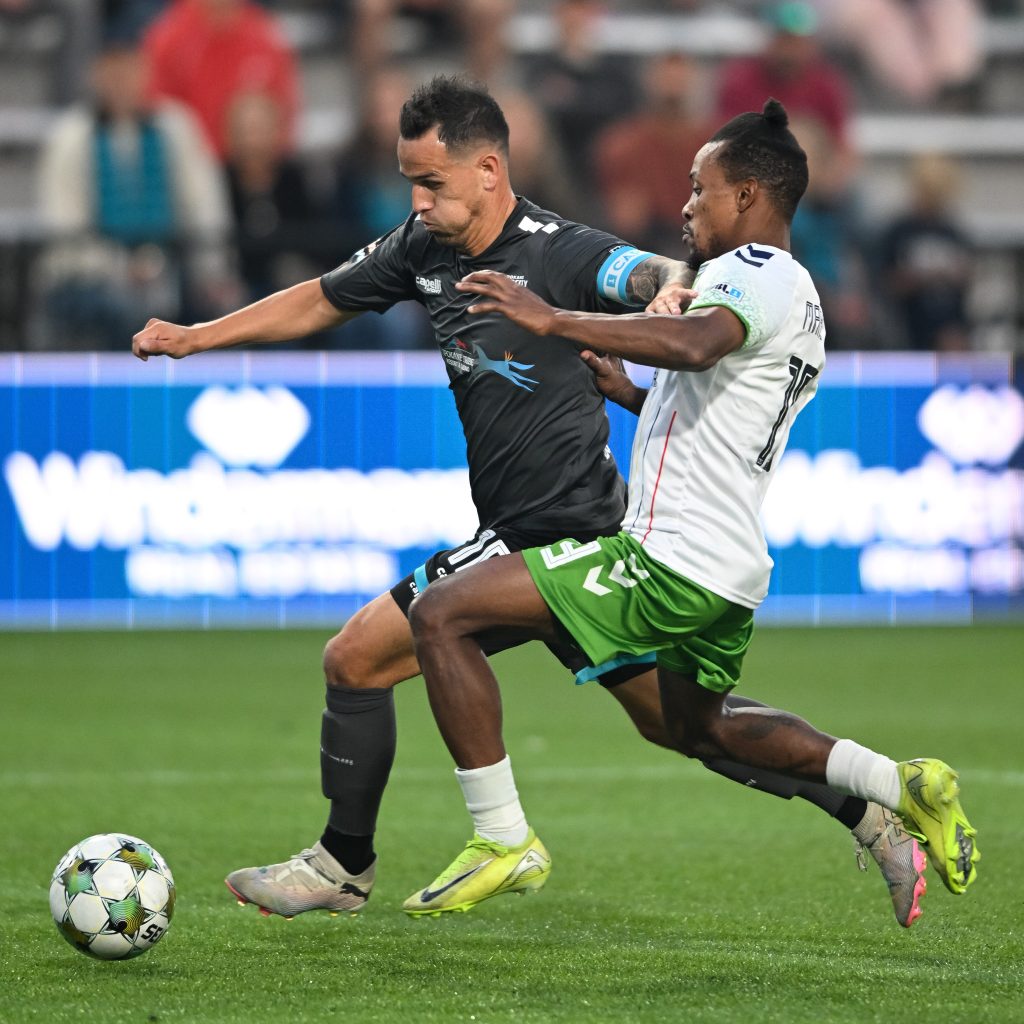 Luis Gil goes head-to-head with a Greenville Triumph player